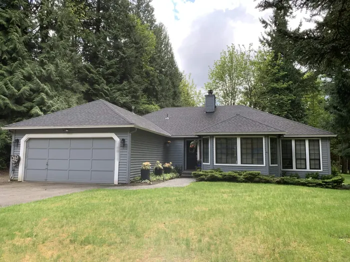 Single-story rambler before: blue-gray siding with white trim