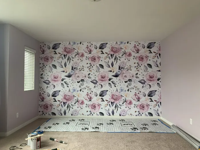 Same bedroom with a floral watercolor wallpaper feature wall and soft lavender walls