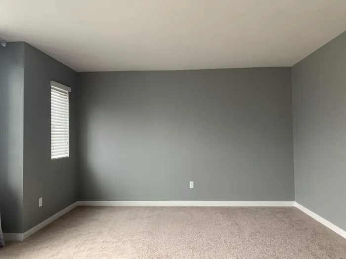 Empty bedroom with plain gray walls