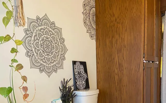 Bathroom wall with large black mandala stencil designs